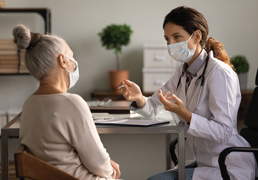 Healthcare professional(right) is talking to the adult patient(left)