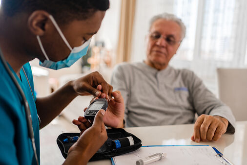 elderly-man-getting-blood-glucose-measured-by-nurse