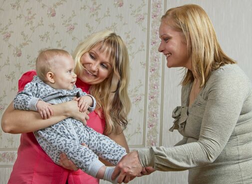 mother and doula playing with baby