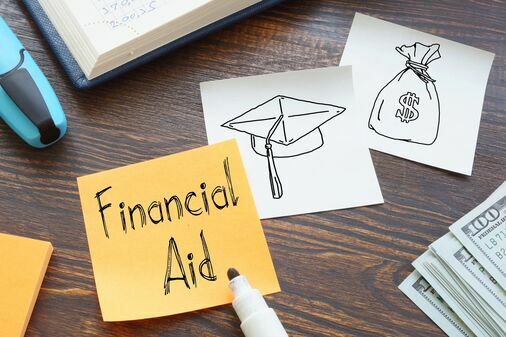 "financial aid" written on sticky note with other doodles